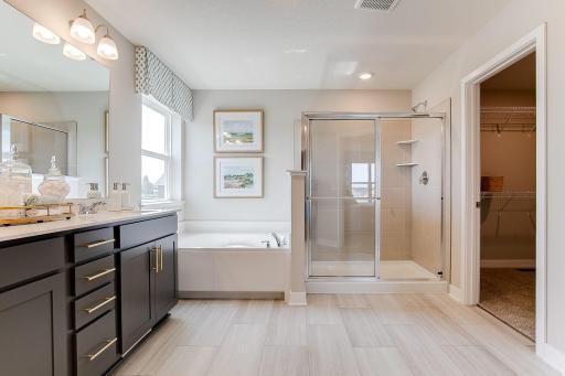 Tiled shower and one of two walk in closets pictured. Photo of model home, colors and finishes will vary.