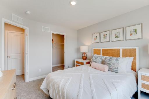 Another gorgeous secondary bedroom with a walk-in closet. Photo of model home, colors and finishes will vary.