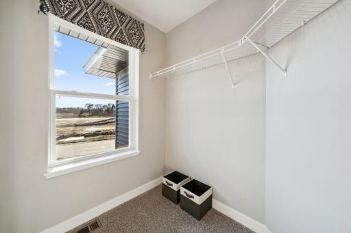 There is a window in the walk in closet that provides natural light! Photo of model home, colors and finishes will vary.