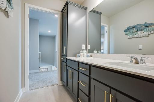 The main bathroom on the upper level includes an oversized vanity and a large linen closet for storage of all your bathroom essentials. Photo of model, colors and finishes will vary.