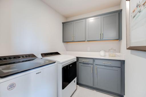 Upper and lower cabinets, plus washer and dryer hookup are included in the laundry room upstairs. Photo of model home, colors and finishes will vary.