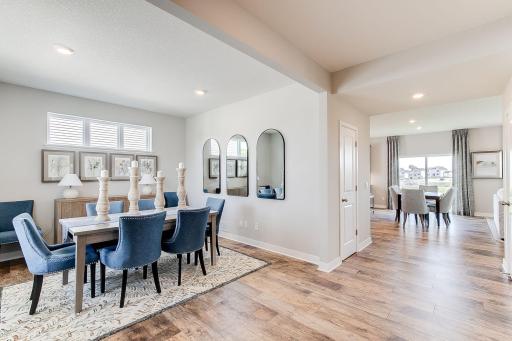 Great windows in your front flex room overlook wide open conservation space with mature trees. Photo of model home, colors and finishes will vary.
