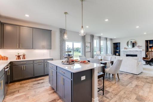There is so much natural light on the main level with oversized windows in the living room and the sliding glass door in the dining room. Photo of model home, colors and finishes will vary.