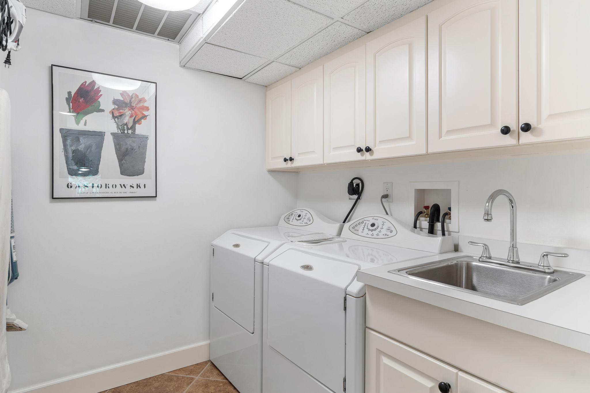 Spacious and cheery laundry room with great storage