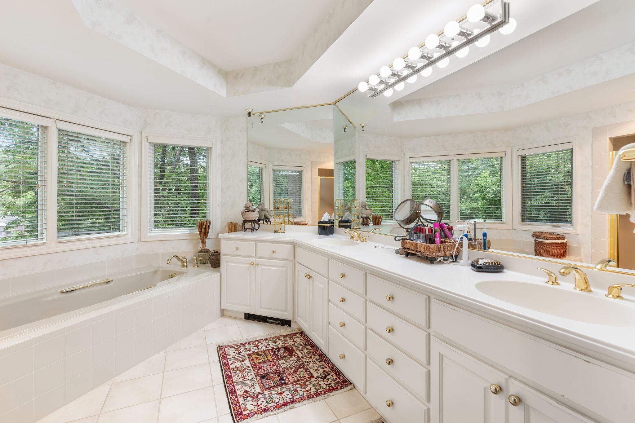 A primary bathroom with great lighting and space