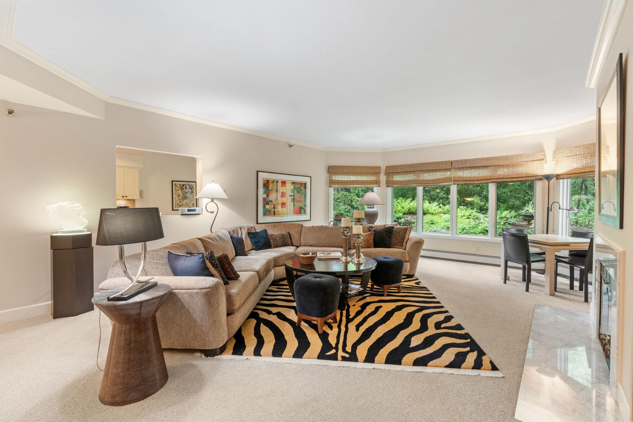 Spacious living room overlooking tranquil and lush grounds