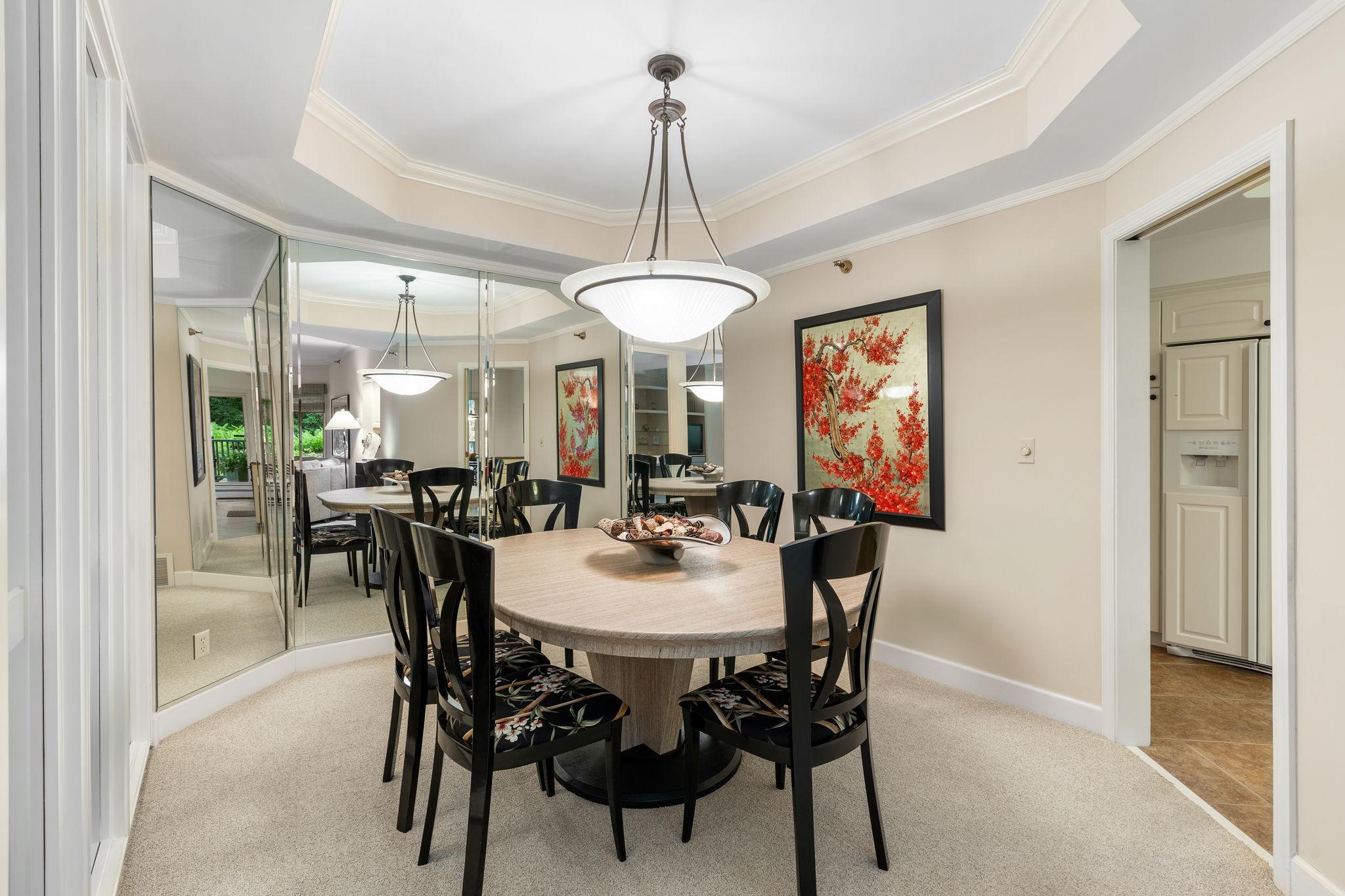 The mirrored wall in the dining room adds drama as well as reflects light for a bright and spacious feel.