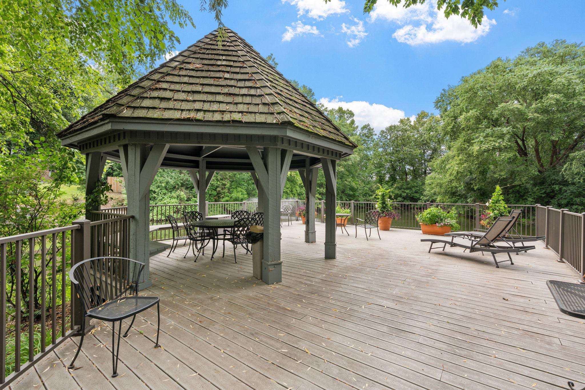 Gazebo overlooks a tranquil pond and fountain