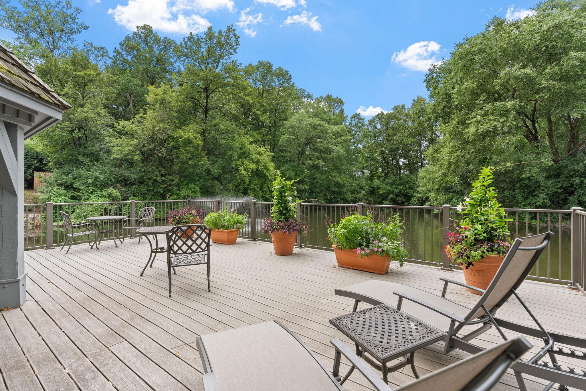 Enjoy the beautiful pond views while relaxing on this sunny deck