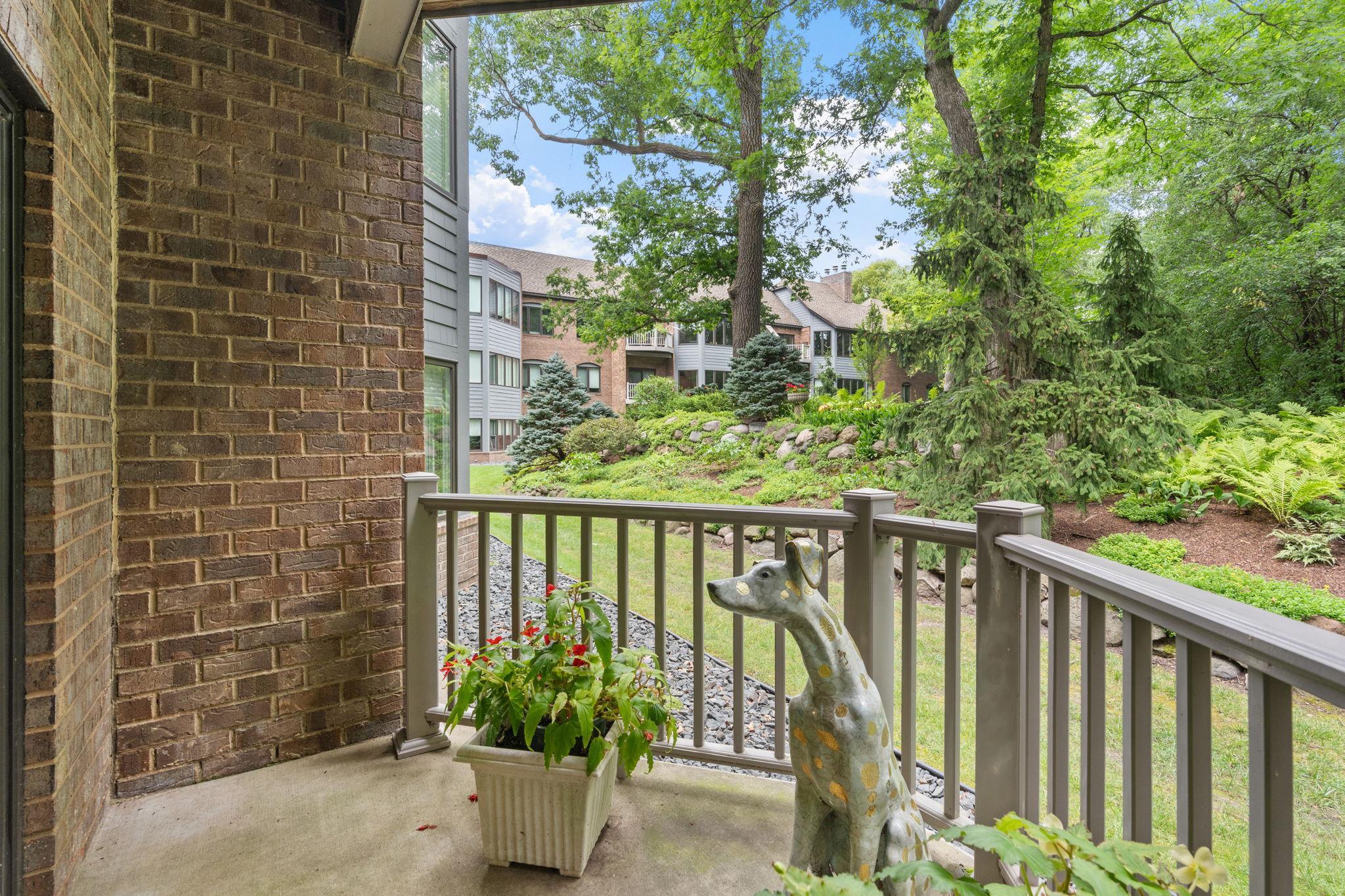Patio off the kitchen offers lush views of the tranquil grounds