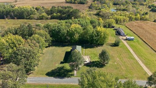 Schoolhouse is almost centered slight left of middle, and goes way back into the trees.