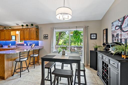 The large dining area is perfectly situated between the kitchen and living room and has wonderful natural light and great views of the wooded and private backyard and deck.