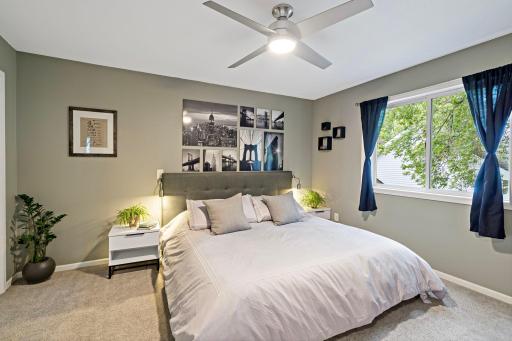 Large primary bedroom on the upper level with neutral decor, ceiling fan, and a large window and an abundance of natural light. 3 Bedrooms on 1 level