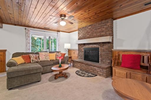 Lower level family room with wood-burning fireplace