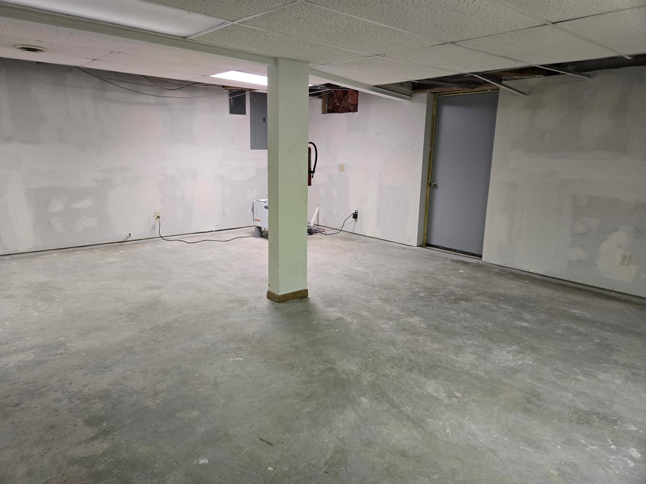 Basement room 1 shows the back basement exit. This space has all new sheetrock and draintile.