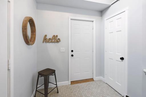 Spacious foyer with closet and sitting area.