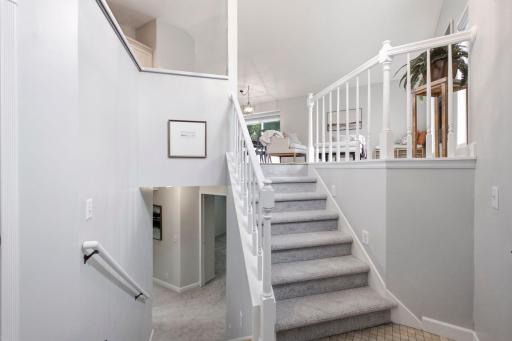 Pristine two-story foyer with new carpet on the stairs and lower level.