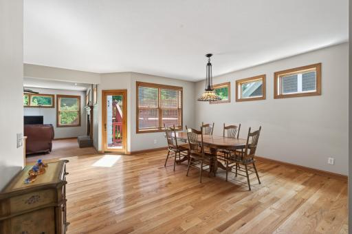 Plenty of natural light! Door to the deck in between the table and living room.