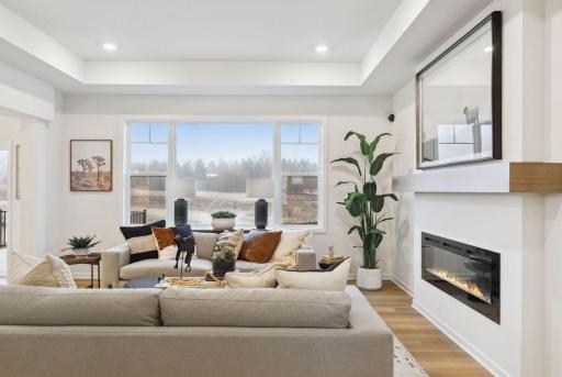 The family room is spacious and has large windows to allow natural light to pour into the home.