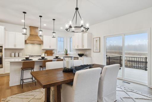 Guests view from the dinning area as it opens to the kitchen and the deck. Perfect for a formal meal or grill night.
