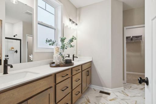 The owner's bath has everything you are looking for with a spacious closet, large two sink vanity, walk in shower and ample storage space.