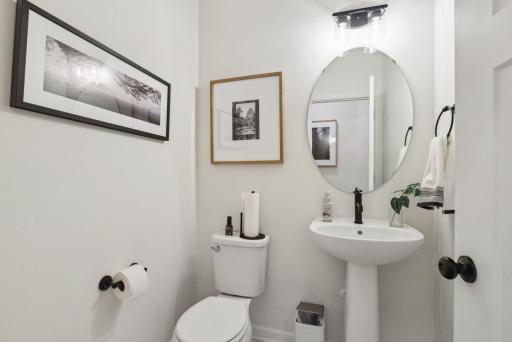 The powder bath provides that necessary second main floor bathroom, conveniently located off the mudroom.
