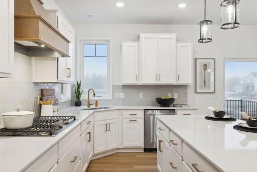 Look at all the counter top, storage space and natural light the kitchen provides! The sink location is ideal as well, not taking up island space where guests like to gather.