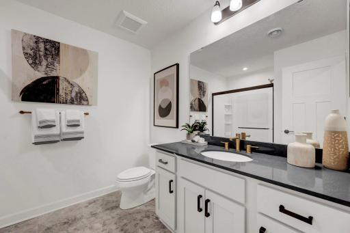 The main bath is perfect for servicing the main level secondary bedroom as well as the rest of the main level. (model photo)