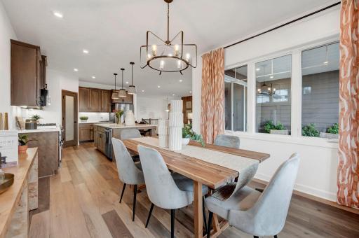 Alternate view of the dining room, even this space is filled with natural light due to all the large windows. (model photo)