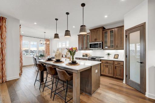 The kitchen offers true eat in capabilities and is anchored by a large center island. (model photo)