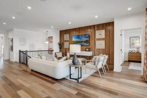 Guest perspective of the family room as it seamlessly flows to the kitchen and dining areas. (model photo)