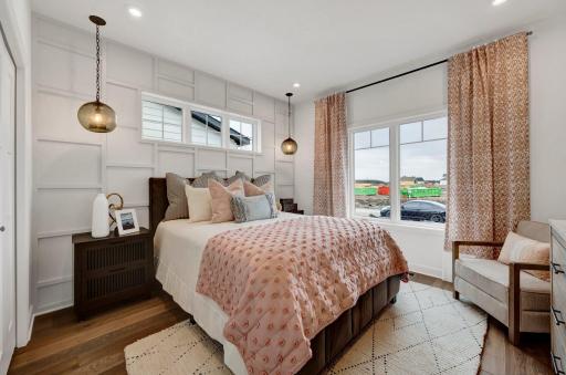 The secondary bedroom on the main level makes for a great space for short or long term guests. (model photo)