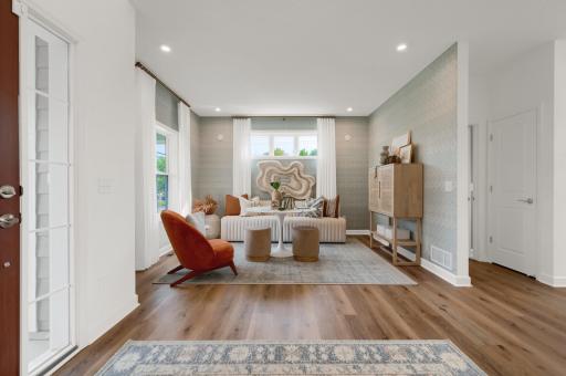 The versatile layout of this home also included this airy flex room, ideal for a home office or another sitting area. (model photo)