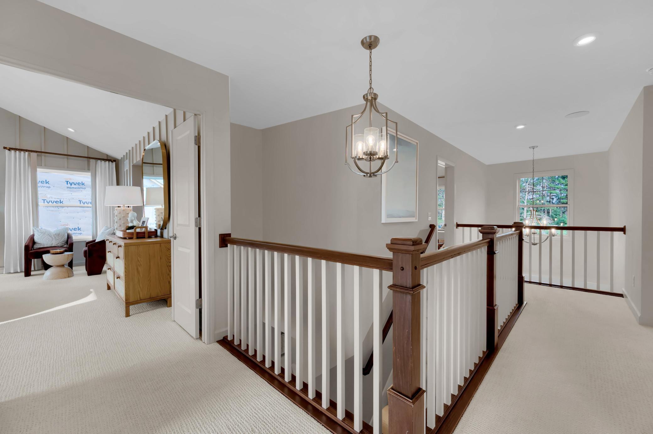 The two story entrance creates a lasting impression as the stairway leads to the home's upper level. (model photo)