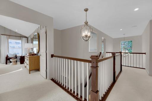 The two story entrance creates a lasting impression as the stairway leads to the home's upper level. (model photo)