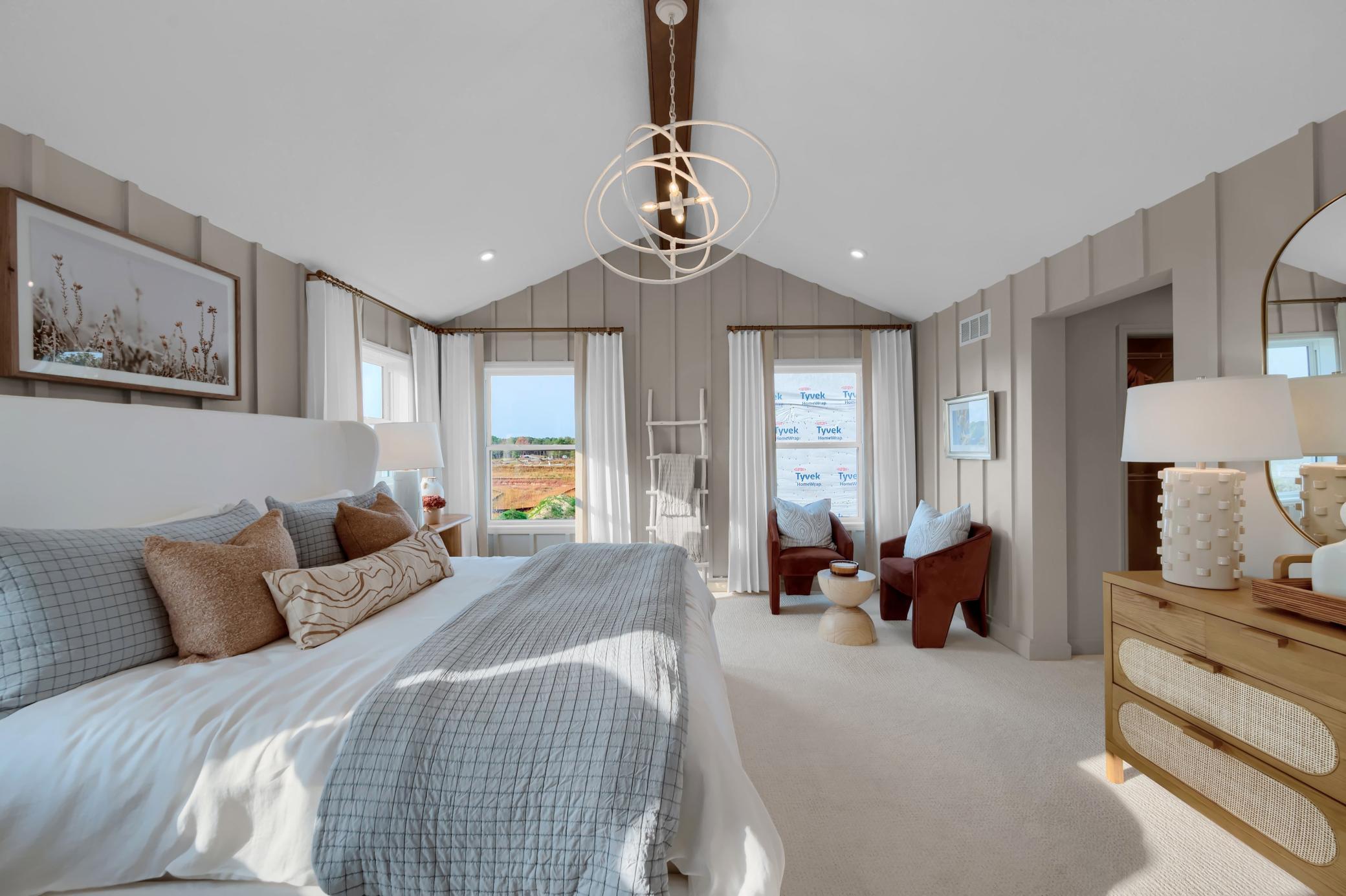 Wake up to soft light and calming vibes in this stylish owner's suite complete with plush carpet and large windows an ideal space to personalize and make entirely your own. (model photo)