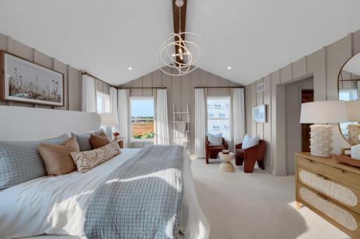 Wake up to soft light and calming vibes in this stylish owner's suite complete with plush carpet and large windows an ideal space to personalize and make entirely your own. (model photo)
