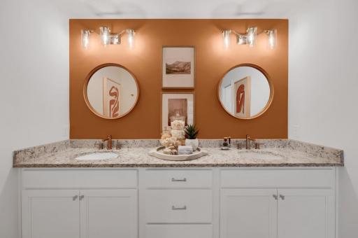 The owner's bath has everything you are looking for with a large two sink vanity, walk in shower and look at all the storage space! (model photo)