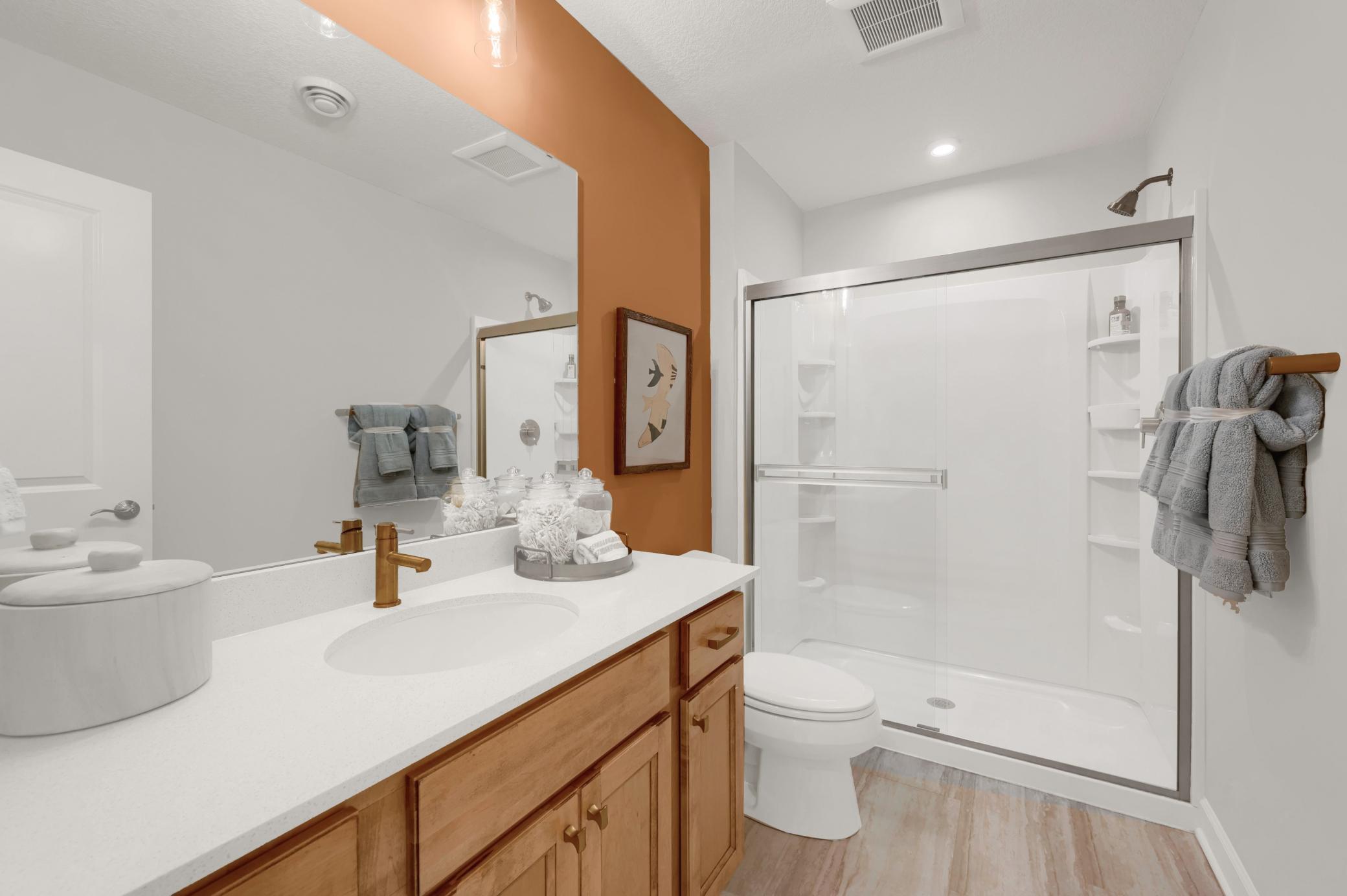 The lower level bath is stunning and spacious! It is ideal for servicing the lower level rec room and lower level bedroom. (model photo)