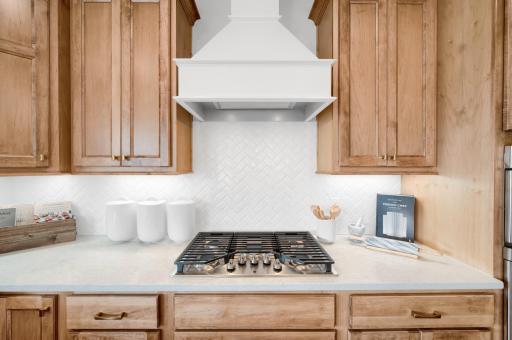 This home has stunning designer selected finishes seen in every detail of the home, including those selection in the beautiful gourmet kitchen. (model photo)