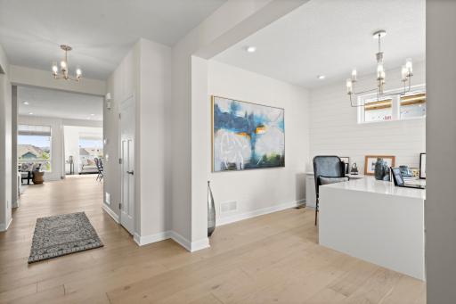 A bright and welcoming foyer featuring luxury vinyl plank flooring provide clean sightlines that immediately showcase the home's open and functional layout. (model photo)