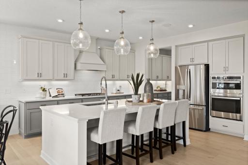 The kitchen is such a gathering place for todays households and this home delivers as the ideal place to host friends and guests alike. (model photo)