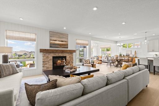 Another view of the family room, this space is perfect for hosting and entertaining but also a cozy space to enjoy a movie night by the fireplace. (model photo)