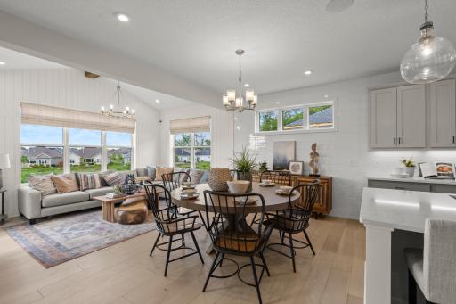 The kitchen and dining area flow seamlessly to the home's morning room. (model photo)