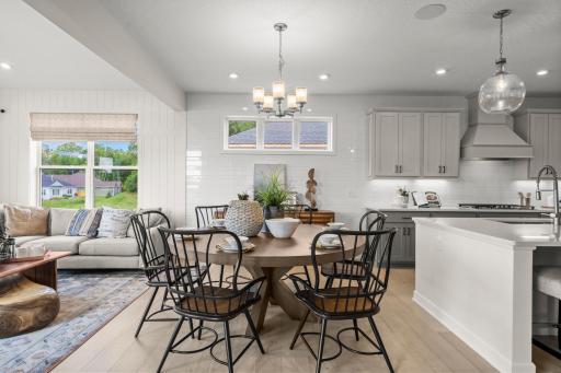 The elegant dining space with modern lighting is perfect for both formal dinners or casual meals (model photo)