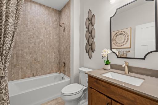 The main floor full bath works perfectly for servicing the main floor or as a bathroom for a guest to utilize. (model photo)