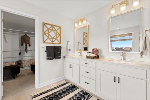 The owner's bath has everything you are looking for with a spacious closet, large two sink vanity, walk in shower and ample storage space. (model photo)