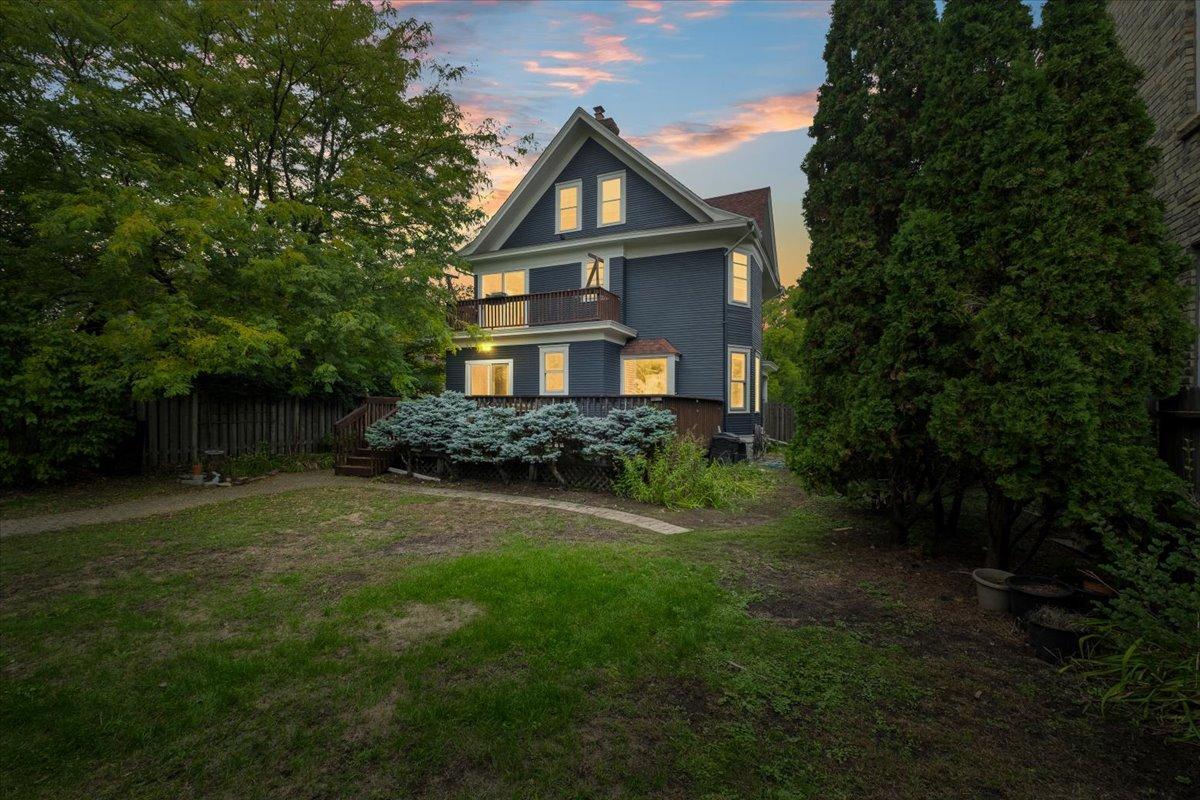 A view of the back of the home and yard