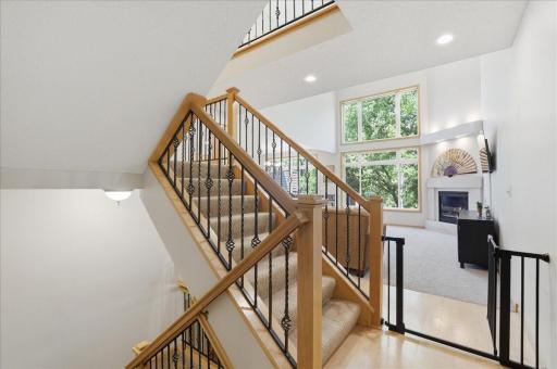 Luxurious, wrought iron railings on every level, Floor to ceiling vaulted windows with tree, tree-top, woods garden and lake views. Stunning year-round.