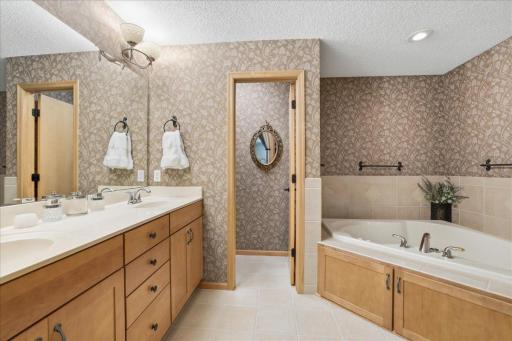 Luxurious primary suite with dual sinks, saperate oversized tub and shower, water closet, walk-in closet.